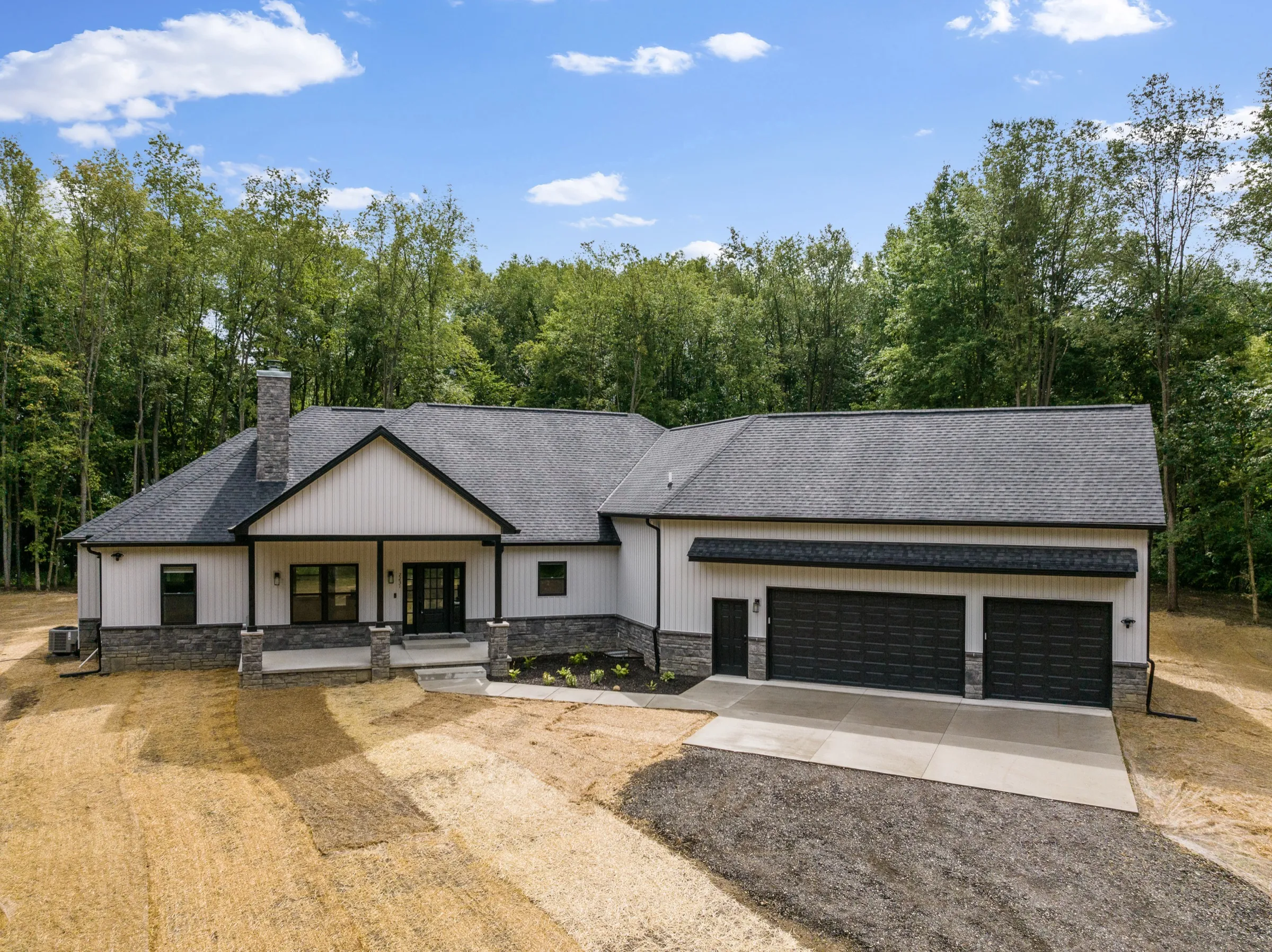Aerial view of the finished house with its three-car garage, taken before the lot was seeded.