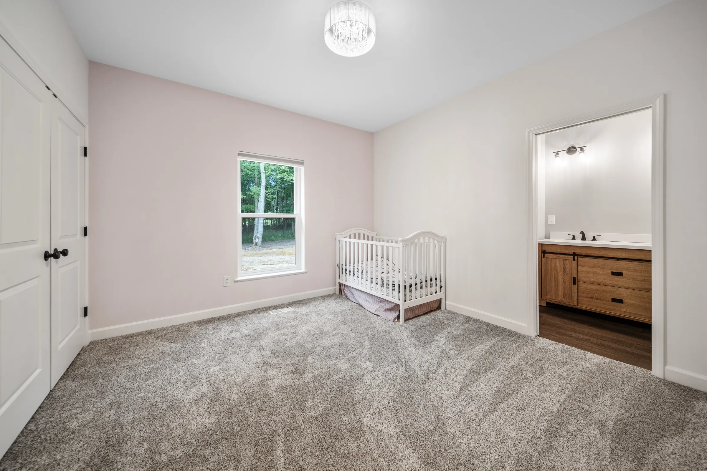 Laundry room with washer and dryer, a patterned tile accent strip and a door through to the garage.